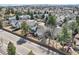 Aerial view of a home with a fenced backyard, mature trees, and neighborhood setting at 6651 Yale Dr, Highlands Ranch, CO 80130