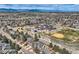Overhead shot of the neighborhood with a school, playground, and sports field in view at 6651 Yale Dr, Highlands Ranch, CO 80130