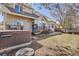 Backyard view with a well-maintained lawn, deck, hot tub, and mature trees at 6651 Yale Dr, Highlands Ranch, CO 80130