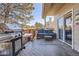 Back deck with a grill, hot tub, outdoor seating, and access to the home's interior at 6651 Yale Dr, Highlands Ranch, CO 80130