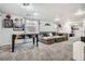 Basement recreational area featuring a foosball table, sectional sofa, and large carpeted area at 6651 Yale Dr, Highlands Ranch, CO 80130