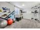 Basement gym with workout equipment, shoe rack, and gray carpet at 6651 Yale Dr, Highlands Ranch, CO 80130