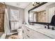 Bathroom showcasing double sink vanity, shower-tub combo, and ample lighting at 6651 Yale Dr, Highlands Ranch, CO 80130
