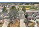 Home's exterior with mature trees, landscaping, and a two-car garage at 6651 Yale Dr, Highlands Ranch, CO 80130