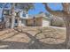 Charming two-story home featuring a brick facade, a blue front door, and a two-car garage at 6651 Yale Dr, Highlands Ranch, CO 80130
