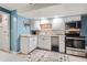 Updated kitchen with white cabinets, stainless steel appliances, and a colorful rug at 6651 Yale Dr, Highlands Ranch, CO 80130