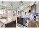 Well-lit kitchen with a granite counters, stainless steel appliances, and island at 6651 Yale Dr, Highlands Ranch, CO 80130