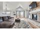 Bright living room with a brick fireplace, high ceilings, and large windows at 6651 Yale Dr, Highlands Ranch, CO 80130