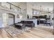 Open-concept living room with hardwood floors, high ceilings, and a kitchen in the background at 6651 Yale Dr, Highlands Ranch, CO 80130