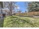 Expansive backyard with a lush lawn, mature trees, and a wood fence, ideal for outdoor living at 145 S Buchanan Ave, Louisville, CO 80027