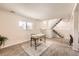 Basement area featuring a desk, stairs to the main level, and natural light from a window at 145 S Buchanan Ave, Louisville, CO 80027