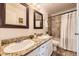 Bathroom offers double sinks with granite counters, framed mirrors and a shower-tub combination at 145 S Buchanan Ave, Louisville, CO 80027