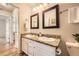 Bathroom featuring double sinks, granite countertops, and well-lit vanity mirrors at 145 S Buchanan Ave, Louisville, CO 80027