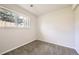 Well-lit bedroom with neutral carpet and a window providing peaceful views of the fenced-in backyard at 145 S Buchanan Ave, Louisville, CO 80027