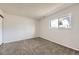 Bright bedroom with neutral carpet and a large window providing ample natural light and neighborhood views at 145 S Buchanan Ave, Louisville, CO 80027