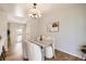 Charming dining area with hardwood floors, neutral decor, and seating for four, next to the open concept kitchen at 145 S Buchanan Ave, Louisville, CO 80027