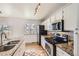 Well-equipped kitchen with granite countertops, stainless steel appliances, white cabinets, and hardwood floors at 145 S Buchanan Ave, Louisville, CO 80027