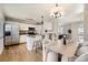 Open kitchen and dining area with granite countertops, hardwood floors, stainless steel appliances, and seating for four at 145 S Buchanan Ave, Louisville, CO 80027