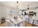 Bright kitchen and dining area features a breakfast bar, modern appliances, and sliding glass door to the deck at 145 S Buchanan Ave, Louisville, CO 80027