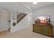 Finished basement area with stairs, doors, and TV, ideal for recreation and relaxation at 12054 E Lake Cir, Greenwood Village, CO 80111