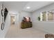 Spacious basement area with TV, and natural light, offering versatile space for various activities at 12054 E Lake Cir, Greenwood Village, CO 80111