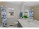 Bright bathroom with a butterfly curtain and a plant on the countertop creating a refreshing ambiance at 12054 E Lake Cir, Greenwood Village, CO 80111