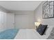 Bedroom featuring a bed with decorative pillows, a closet, and a side table providing comfort and style at 12054 E Lake Cir, Greenwood Village, CO 80111