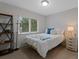 Cozy bedroom with a window and a shelf for storage providing a serene and comfortable retreat at 12054 E Lake Cir, Greenwood Village, CO 80111