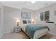 Comfortable bedroom with lamps and framed artwork, designed for relaxation and rest at 12054 E Lake Cir, Greenwood Village, CO 80111