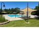 Community pool with shade sails and lounge chairs offering a refreshing recreational space for residents at 12054 E Lake Cir, Greenwood Village, CO 80111