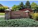 Stone entrance sign for Cottonwood Grove at Greenwood Village surrounded by green hedges and landscaping at 12054 E Lake Cir, Greenwood Village, CO 80111