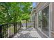 Outdoor deck with metal railing offers a serene view of the surrounding lush greenery, a perfect place to relax at 12054 E Lake Cir, Greenwood Village, CO 80111