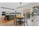 Open-concept dining area with modern lighting fixture, a cozy seating area and sliding doors to outdoors at 12054 E Lake Cir, Greenwood Village, CO 80111