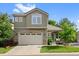 Charming two-story home boasts a manicured front lawn, two-car garage, and inviting curb appeal at 12054 E Lake Cir, Greenwood Village, CO 80111