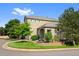 Charming two-story home with a beautifully landscaped front yard and stone accents under a bright blue sky at 12054 E Lake Cir, Greenwood Village, CO 80111