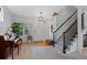 Bright foyer features hardwood floors, a staircase with black railings, and charming decorative accents at 12054 E Lake Cir, Greenwood Village, CO 80111