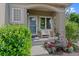 Cozy front porch adorned with beautiful flower pots and a white bench, creating a welcoming entrance at 12054 E Lake Cir, Greenwood Village, CO 80111