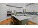 Modern kitchen with stainless steel appliances, center island with seating, and white cabinetry at 12054 E Lake Cir, Greenwood Village, CO 80111