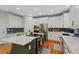 Well-equipped kitchen with stainless steel appliances, island with cooktop, and ample counter space at 12054 E Lake Cir, Greenwood Village, CO 80111