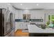 Stylish kitchen with stainless steel appliances, sleek countertops, white cabinetry and modern fixtures at 12054 E Lake Cir, Greenwood Village, CO 80111