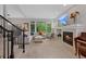 Spacious living room with a fireplace, large windows, and comfortable seating, perfect for relaxation at 12054 E Lake Cir, Greenwood Village, CO 80111
