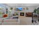 Bright living room with a fireplace, comfortable sectional sofa, and large windows at 12054 E Lake Cir, Greenwood Village, CO 80111
