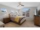 Spacious main bedroom offers a large bed, neutral carpet, with an abundance of natural light at 12054 E Lake Cir, Greenwood Village, CO 80111