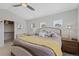 Bright main bedroom includes a walk-in closet, stylish lamps and comfortable furnishings at 12054 E Lake Cir, Greenwood Village, CO 80111