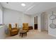 Relaxing sitting area with chairs, a side table, and a view into a bathroom, perfect for unwinding at 12054 E Lake Cir, Greenwood Village, CO 80111