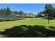 A sunny grass yard has a sand volleyball court ready for some summer fun at 12054 E Lake Cir, Greenwood Village, CO 80111