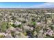 Aerial view of a home surrounded by lush greenery and mature trees in a suburban neighborhood at 4 Brookside Dr, Greenwood Village, CO 80121