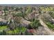Bird's eye view showcases a home surrounded by dense trees, highlighting the property's privacy and natural setting at 4 Brookside Dr, Greenwood Village, CO 80121