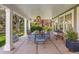 Covered back patio features outdoor dining and views of lush backyard landscaping at 4 Brookside Dr, Greenwood Village, CO 80121