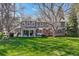 Expansive backyard with a covered patio, picnic table, and mature trees at 4 Brookside Dr, Greenwood Village, CO 80121